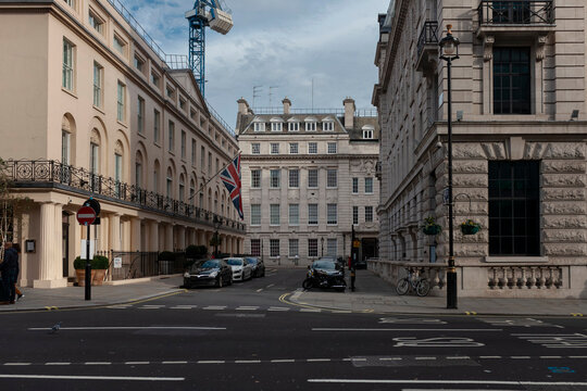 Classic London street with Georgian buildings, Union Jack flag and parked cars