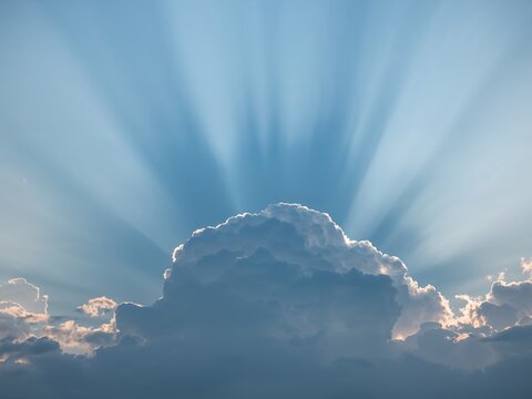 Spectacular Crepuscular Rays Radiating Above Majestic Cumulus Cloud, a Sky Wonder. - Powered by Adobe