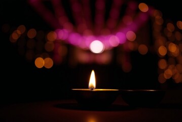 Diwali diyas with bokeh lights 