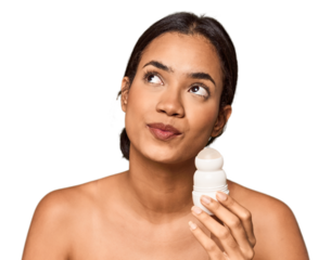 Filipino woman holds deodorant in studio dreaming of achieving goals and purposes