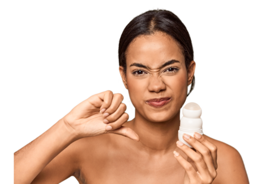 Filipino woman holds deodorant in studio showing a dislike gesture, thumbs down. Disagreement concept.