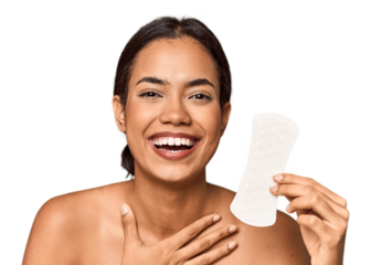 Filipino woman with sanitary pad in studio laughs out loudly keeping hand on chest.