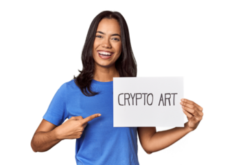 Woman with "crypto art" sign in studio smiling and pointing aside, showing something at blank space.