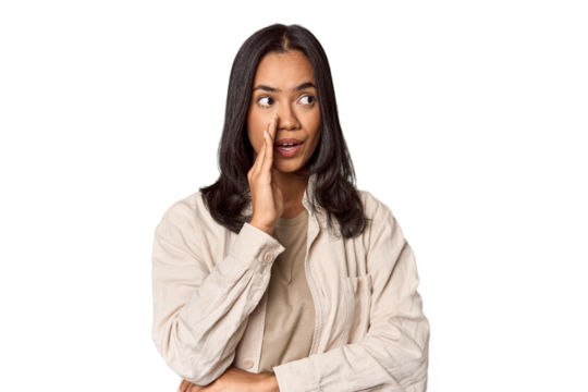 Portrait of a young Filipino woman is saying a secret hot braking news and looking aside - Powered by Adobe