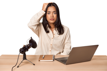 Woman records podcast with laptop being shocked, she has remembered important meeting.