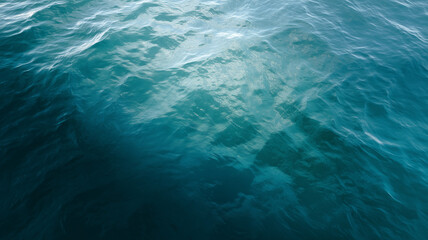 Calm blue water surface with gentle ripples, top down view, natural texture, peaceful and serene ocean scene