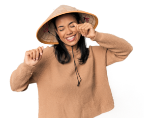 Young Filipina with Vietnamese hat celebrating a special day, jumps and raise arms with energy.