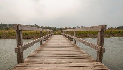 Fototapeta premium Wooden Bridge Over Water with Overcast Sky, a Path to Natures Embrace.