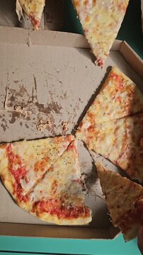 Friends gather to enjoy a freshly baked pizza with melted cheese and crispy crust