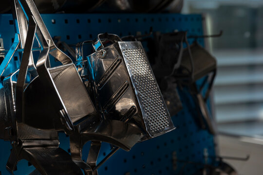 Professional kitchen graters and metal tools hanging in commercial cooking environment