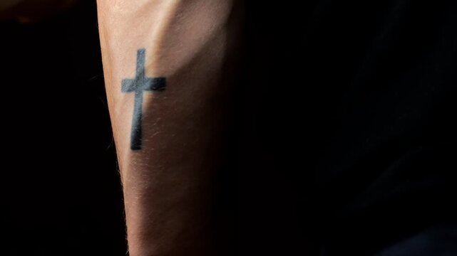 Catholic cross on the arm as a tattoo.
Religious tattoos on the body.
A cross drawn on the skin of a Catholic or Christian.
Faith in God and hope