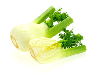 Fresh fennel bulbs sliced showing layers on a white surface