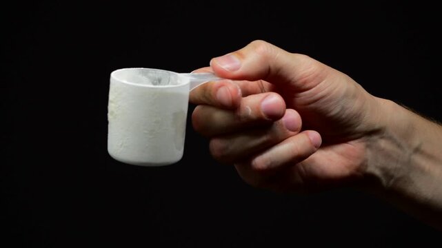 Dry freeze-dried protein in a measuring cup close-up.
Scoop of protein or creatine for athletes.
Protein concentration in the body.
Dry processed protein in a measuring spoon