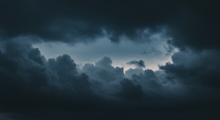 Obraz premium Dramatic cloudscape with swirling dark clouds and contrasting light forming dynamic sky scene