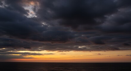 Dramatic sunset sky with dark clouds