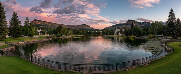Scenic view of a lake reflecting the sky and mountains at sunset time