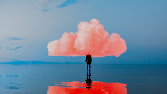 Silhouette of a man beneath a pink cloud over calm sea waters