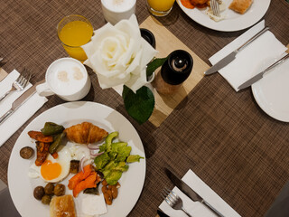 Healthy breakfast variety with eggs, grilled vegetables, avocado, olives, and cheese. Mediterranean breakfast, hotel breakfast, nutrient rich plate, slow food morning