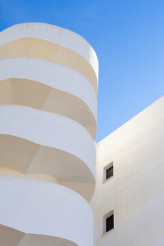 Geometric facade against clear blue sky