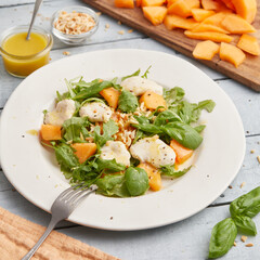 Mozzarella melon arugula salad