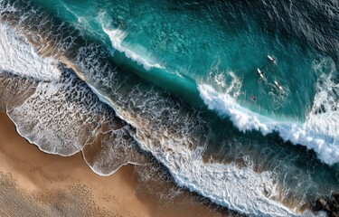 This is an aerial view that showcases waves crashing onto a sandy beach