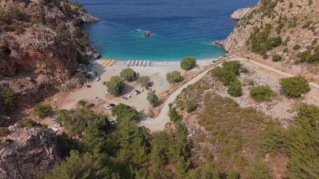 Aerial drone shot revealing the panoramic landscape of Achata Beach in Karpathos, Greece.