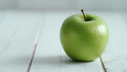 Green apple on a white wooden surface