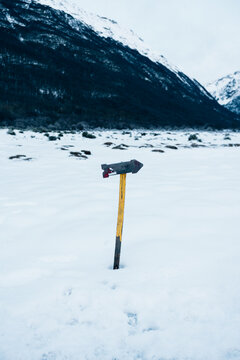 Snowy landscape with rustic arrow signpost in Patagonia