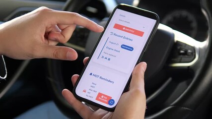 Hands update a vehicle service record in a maintenance tracking app, demonstrating responsible ownership. Ideal for automotive care tutorials, tech reviews, or organizational content.