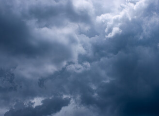 Dramatic dark storm clouds in overcast sky before thunderstorm and heavy rain - moody weather background for climate and meteorology concepts.