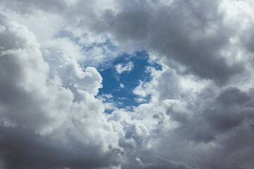 Fototapeta premium Cloudscape background. Sky view in the middle of dense clouds