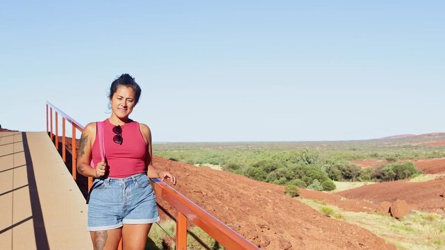 Female traveler walking near the red desert landscapes of Australia