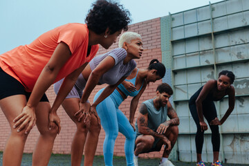 Group of athletes recovering after intense outdoor training