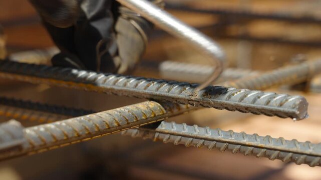 Strapping of reinforcing steel rods in foundation construction close up view