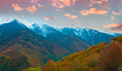 Fototapeta premium Breath taking view of evening sunset scene a mountain in Autumn scene with snow at Mestia Georgia, autumn forest