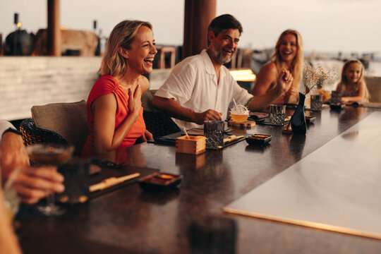 Group enjoying fine dining together at a luxurious restaurant ambiance outdoors