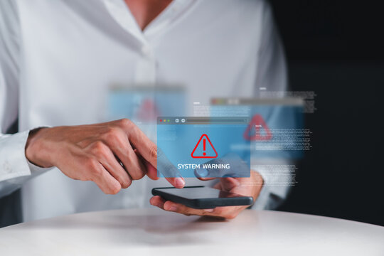Man touching smartphone screen with system warning alert popup, showing a digital threat or data breach. Concept of mobile cybersecurity, virus detection, and online information risk.