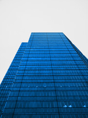Modern building architecture abstract background Industrial building wide angle looking up at sky Blue glass windows	