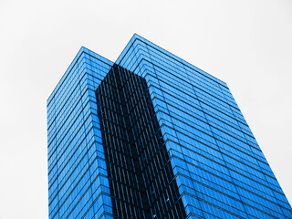 Modern building architecture abstract background Industrial building wide angle looking up at sky Blue glass windows	