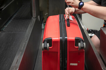 Baggage tagging by airline staff before luggage dispatch