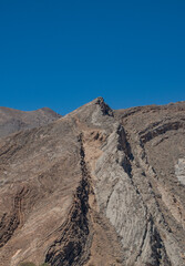 Oman, Middle East: driving on the roads of the Sultanate of Oman, details of mountains and desert landscape on the road between Muscat and Nizwa crossing remote villages