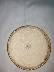 Elegant Gold and Cream Lace Doily on Round Tray: Decorative Plate Design