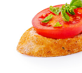 Fresh tomato and basil atop crusty bread slice with vibrant colors