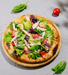 Delicious salad pizza topped with fresh vegetables and grilled chicken