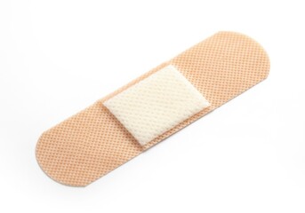A single beige adhesive bandage with a white sterile pad isolated on a white background