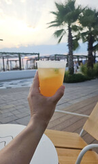 Coastal sunset elixir amidst palm silhouettes, celebrating Margarita Day with zest, relaxation in liminal tropical serenity