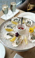 Chilled oysters nestle with vibrant pansies and zesty lemons, evoking an avant-garde New Year's Eve fete or Seafood Appreciation Day