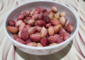 A treasure trove of pink pepitas nestled in a ceramic bowl, evoking a blend of Autumn Equinox bounty and Peruvian heritage kitchens