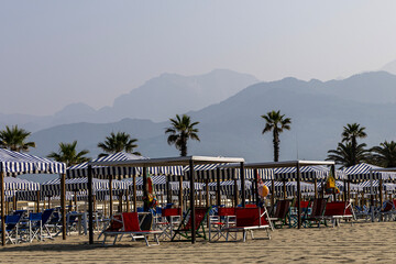 Beach umbrellas and sun loungers at the tourist resort, Tyrrhenian Sea, Viareggio, Italy.