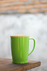 bright green plastic cup on table with bokeh background